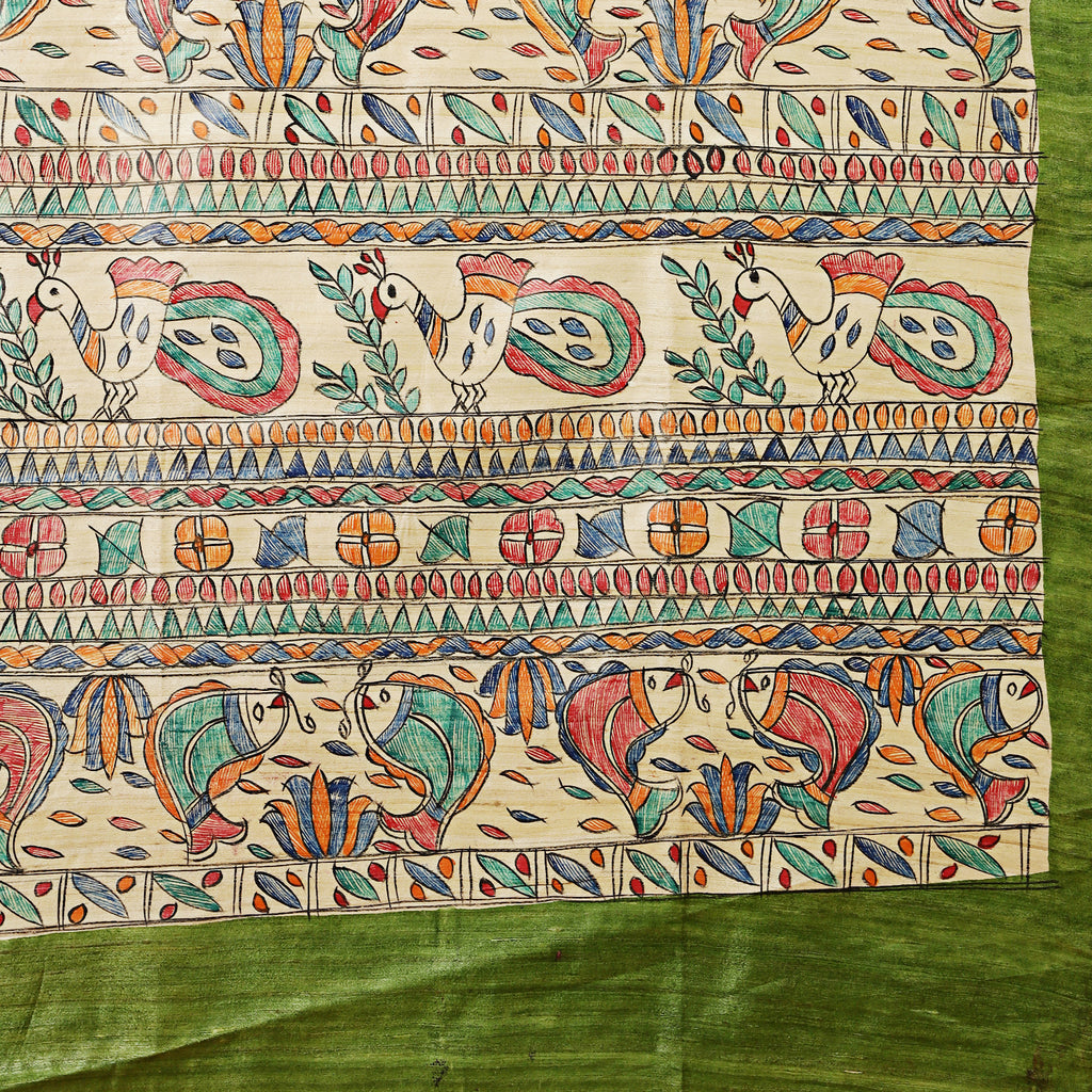 Colorful patterned fabric with birds and geometric designs on a green background