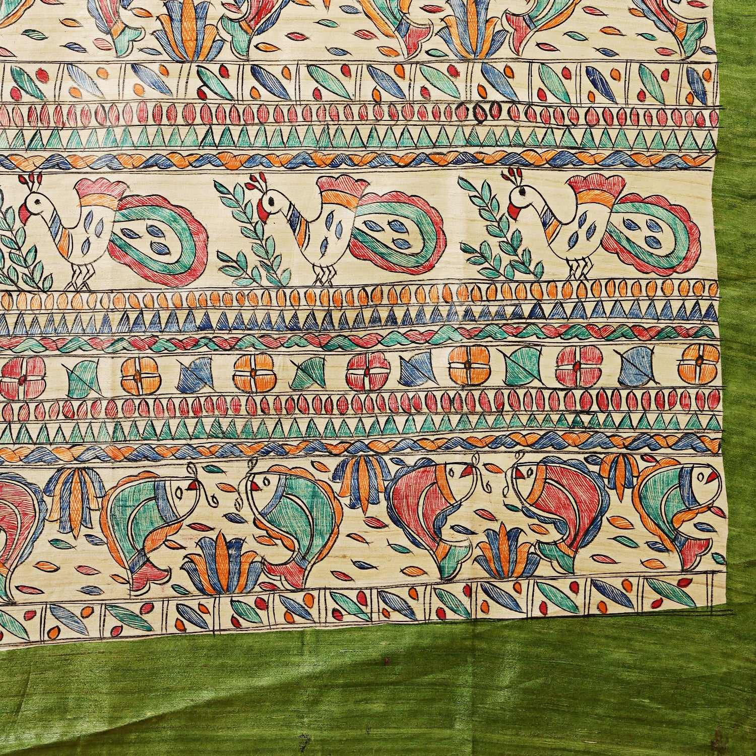 Colorful patterned fabric with birds and geometric designs on a green background