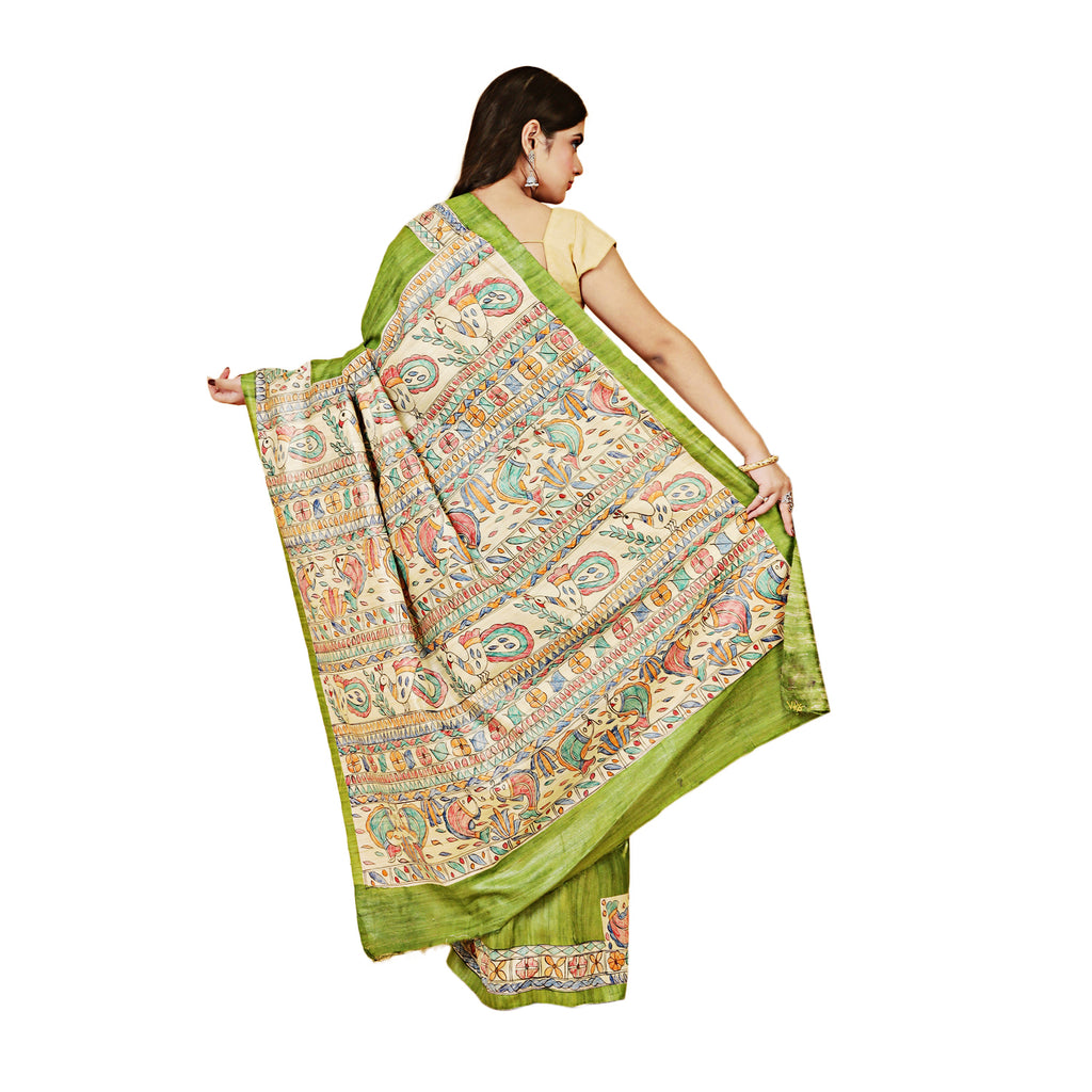 Woman wearing a traditional saree with a green border on a white background